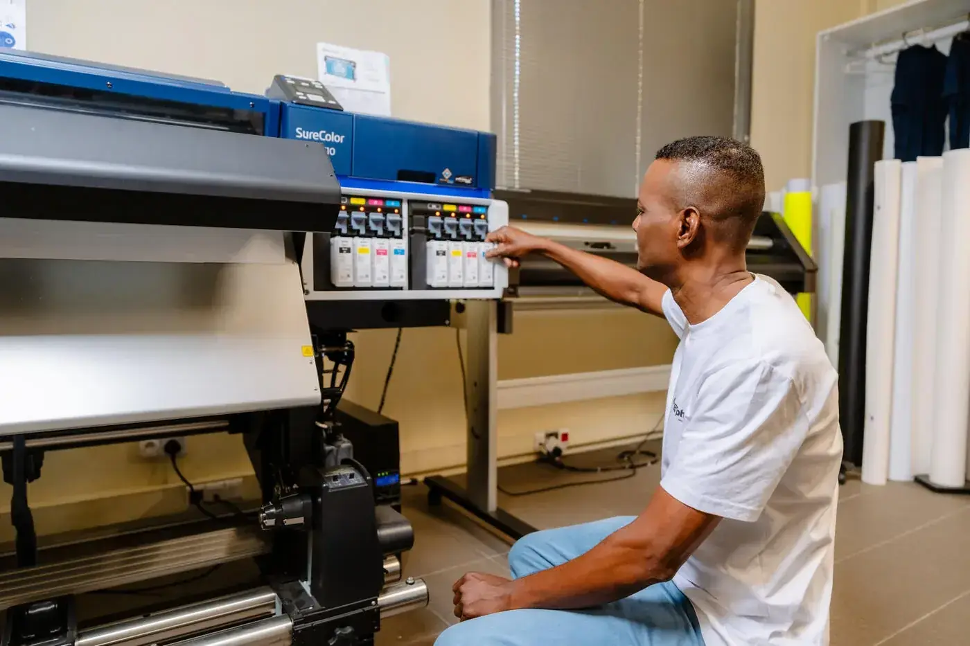 Intergraph technician at an Epson SureColor large-format printer